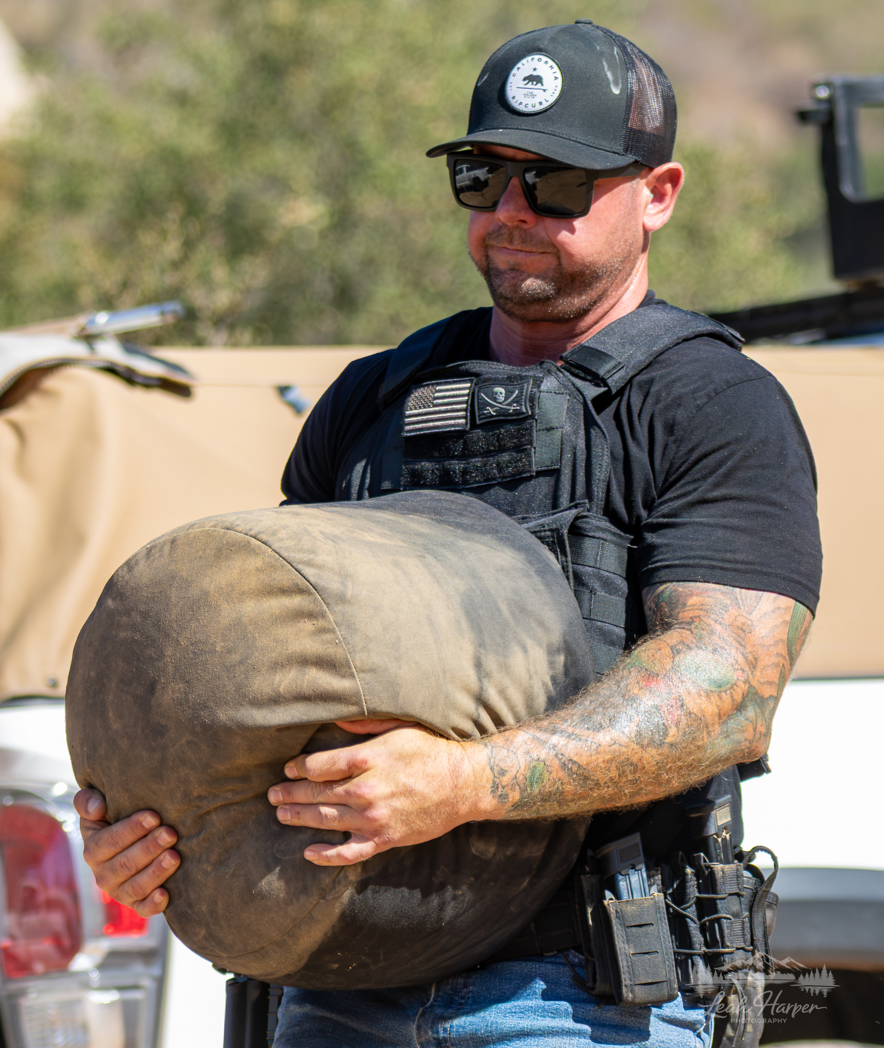 Tactical athlete carrying a sandbag