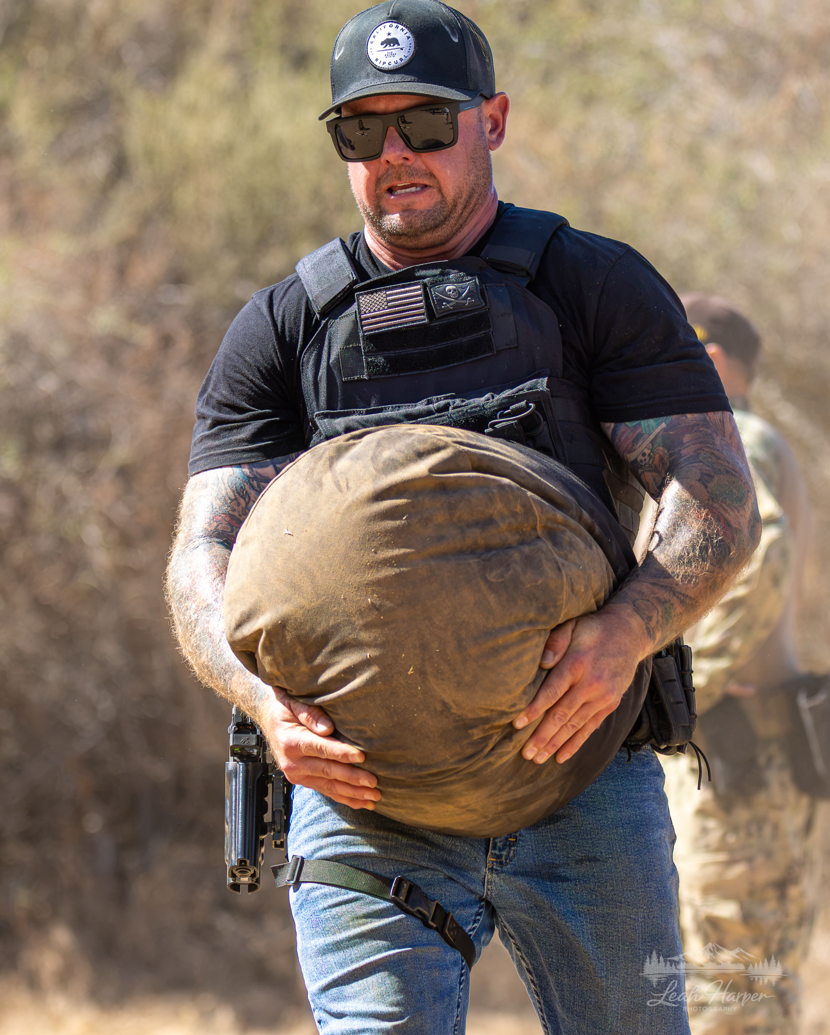 Tactical Athlete carrying a sandbag during a field event